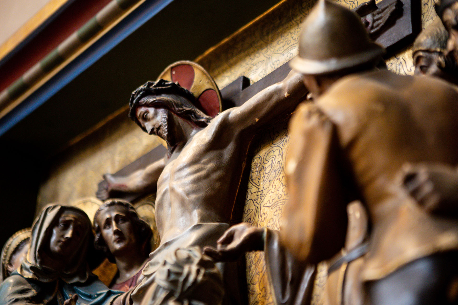 Carved religious statue and devotional artwork inside the church